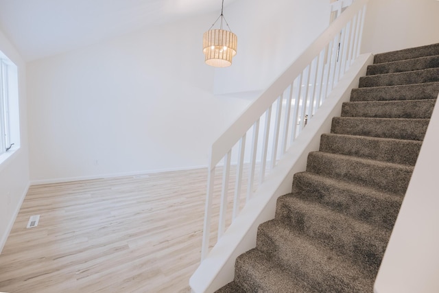 stairway with hardwood / wood-style flooring