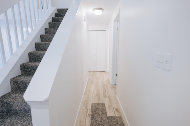 stairs featuring wood-type flooring