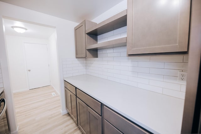 kitchen with decorative backsplash and light hardwood / wood-style flooring