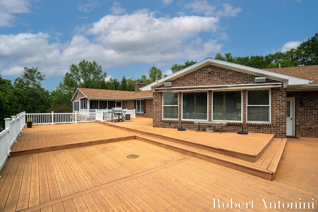 wooden terrace featuring area for grilling