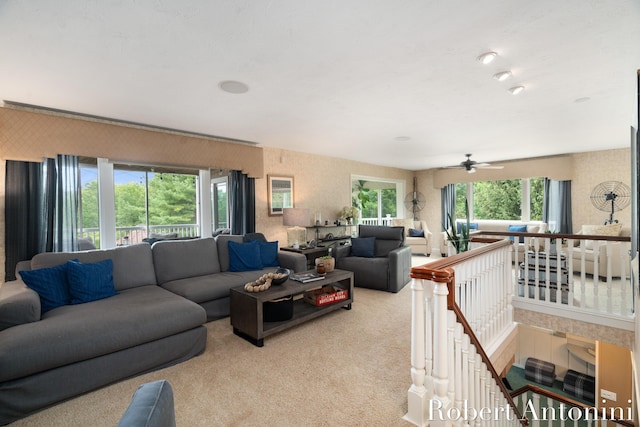 carpeted living room with ceiling fan