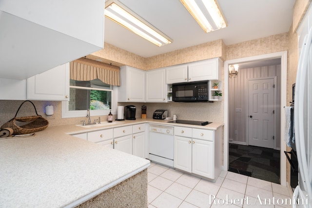 kitchen with light tile patterned floors, sink, white cabinets, and black appliances