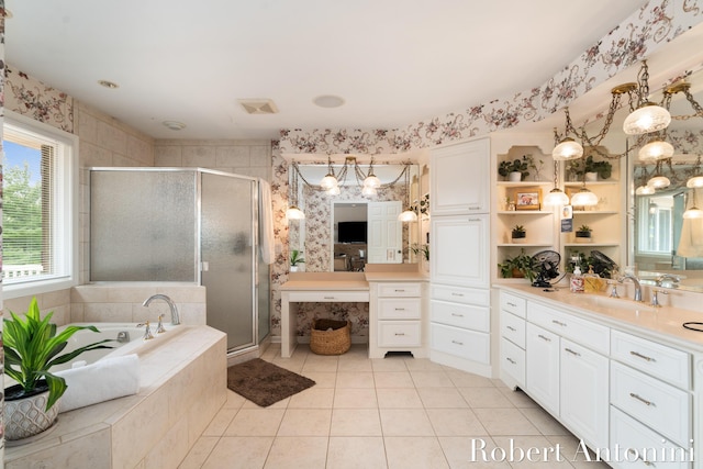 bathroom with walk in shower, vanity, and tile patterned flooring