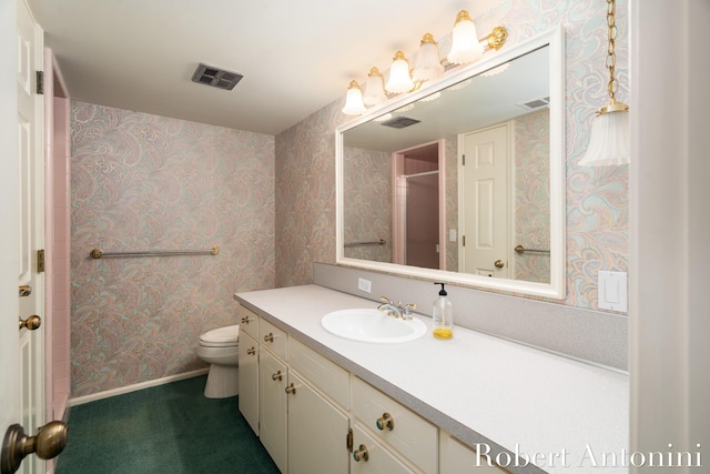 bathroom with toilet and vanity