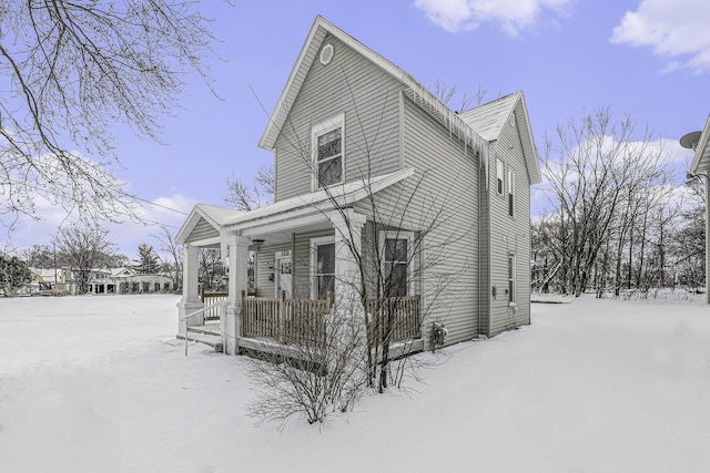 view of snow covered exterior featuring a porch