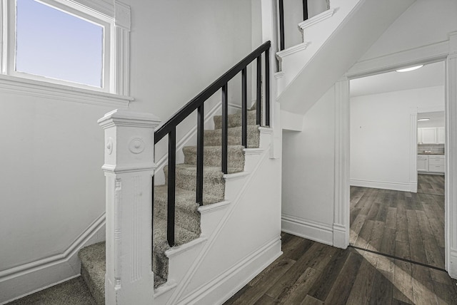 stairs featuring hardwood / wood-style flooring