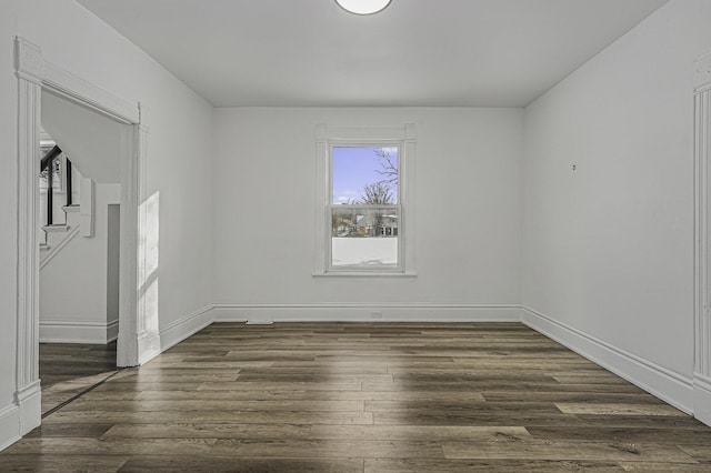 unfurnished room featuring dark hardwood / wood-style floors