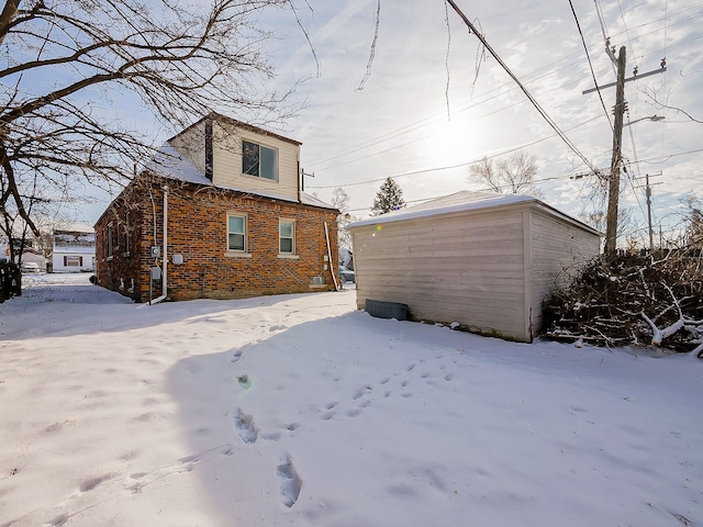 view of snow covered back of property