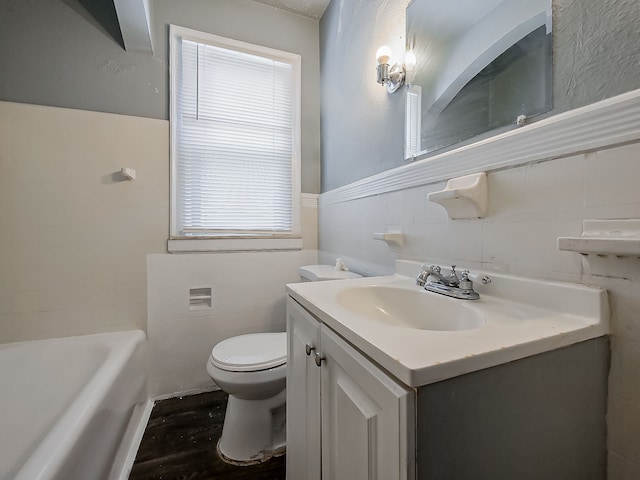 bathroom featuring toilet, vanity, a bathtub, and wood-type flooring