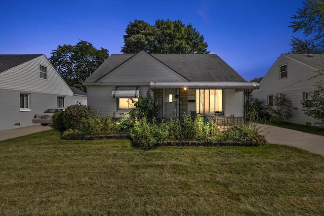 view of front of house with a porch and a lawn