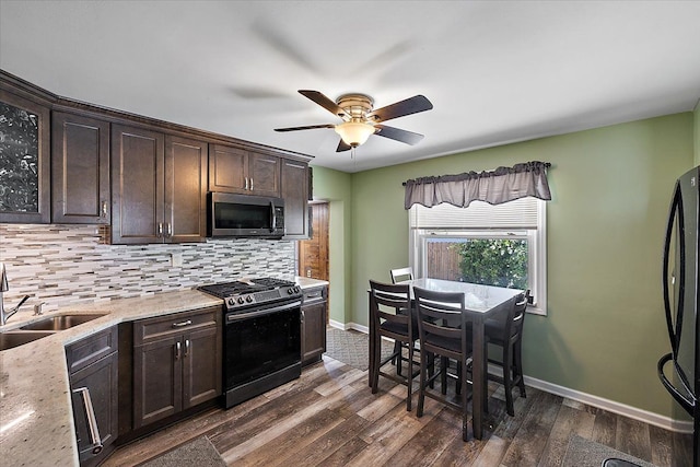 kitchen featuring stainless steel appliances, tasteful backsplash, sink, ceiling fan, and dark brown cabinets