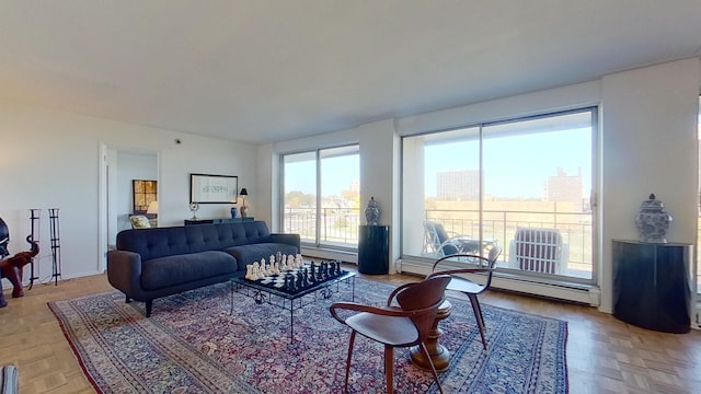 living room with baseboard heating and light parquet floors