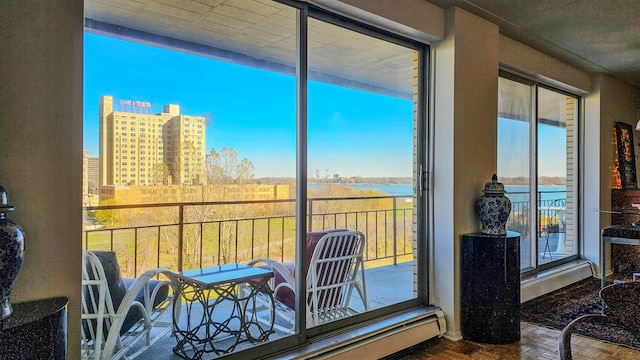 sunroom featuring a water view