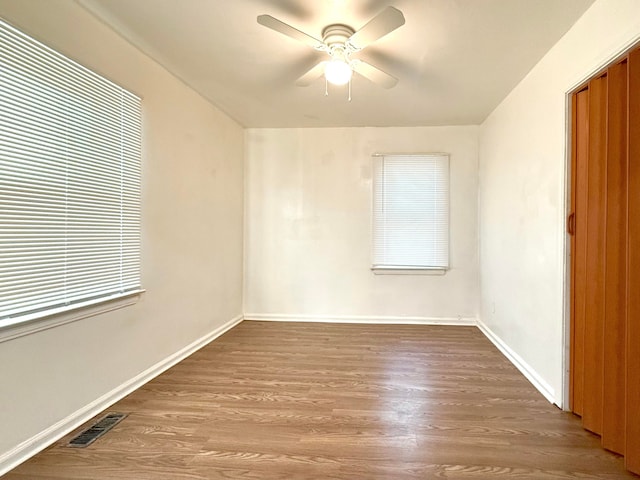 empty room featuring ceiling fan and wood-type flooring