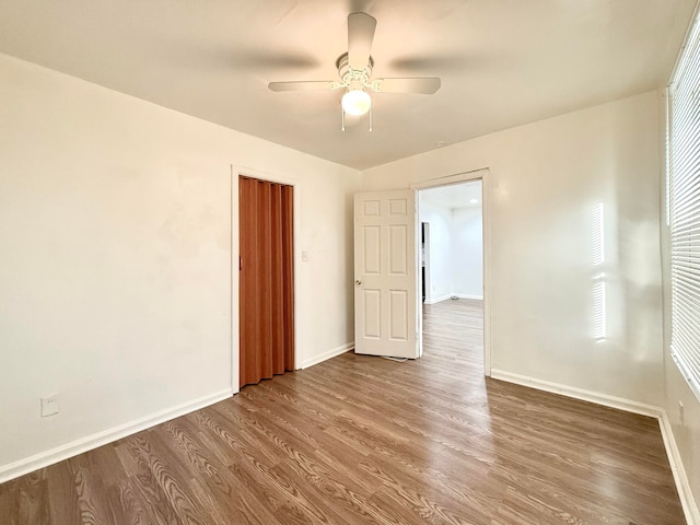 empty room with ceiling fan and hardwood / wood-style floors