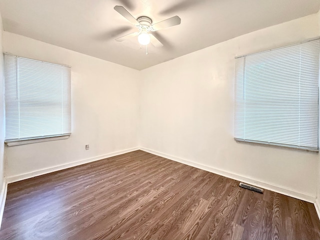 empty room featuring ceiling fan and dark hardwood / wood-style floors