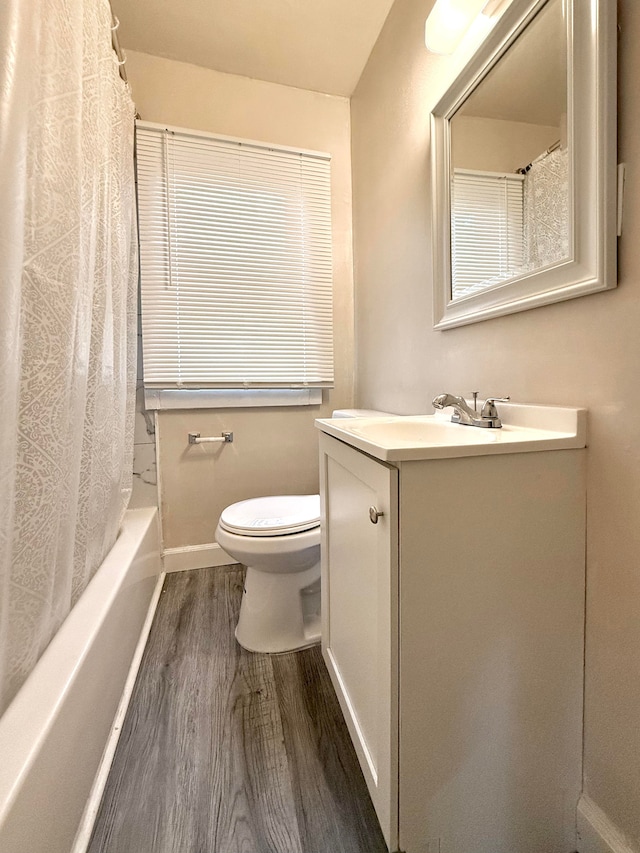 full bathroom with toilet, shower / tub combo, hardwood / wood-style floors, and vanity