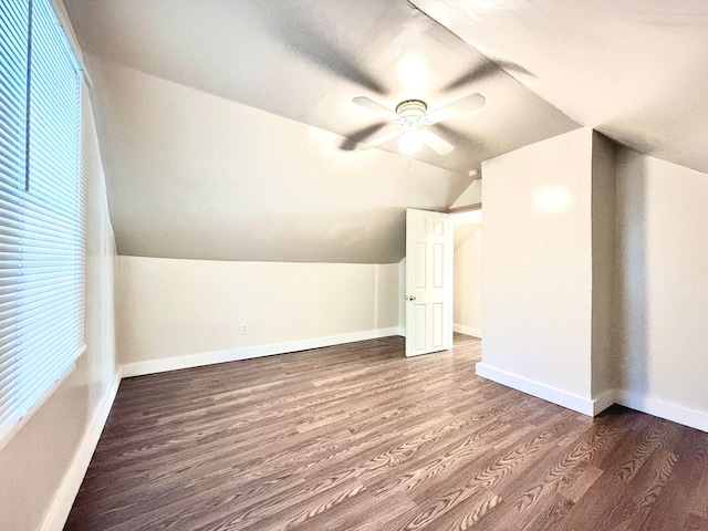 bonus room with vaulted ceiling, ceiling fan, plenty of natural light, and dark hardwood / wood-style floors