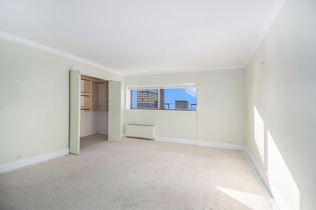 carpeted spare room featuring radiator heating unit and ornamental molding