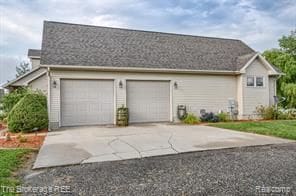 view of side of home featuring a garage