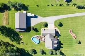 birds eye view of property with a rural view