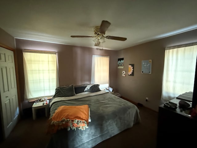 bedroom with ceiling fan and a closet