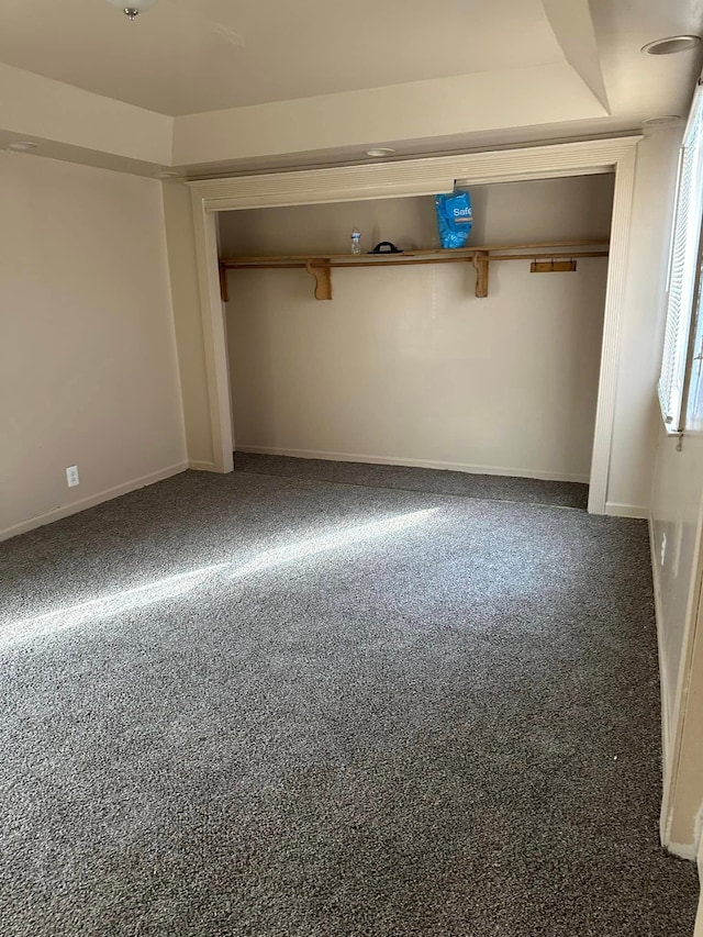 unfurnished bedroom with carpet and a closet