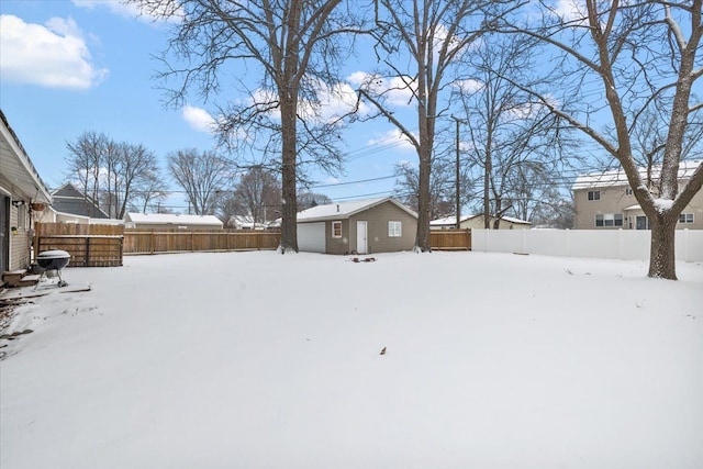 yard layered in snow featuring an outbuilding