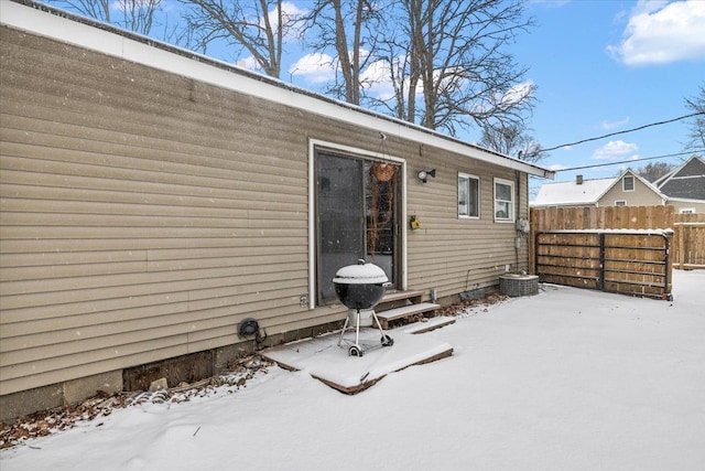 view of snow covered back of property