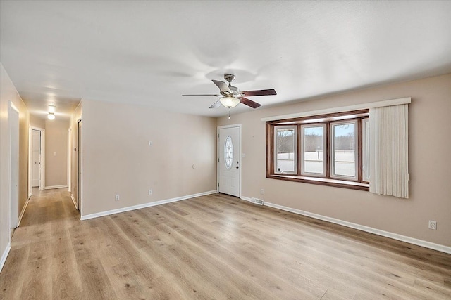 spare room featuring ceiling fan and light hardwood / wood-style flooring