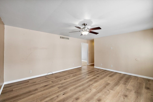 spare room featuring ceiling fan and light hardwood / wood-style flooring