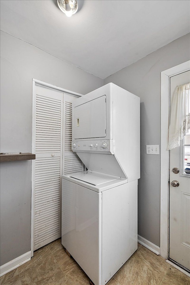 laundry area featuring stacked washer and clothes dryer