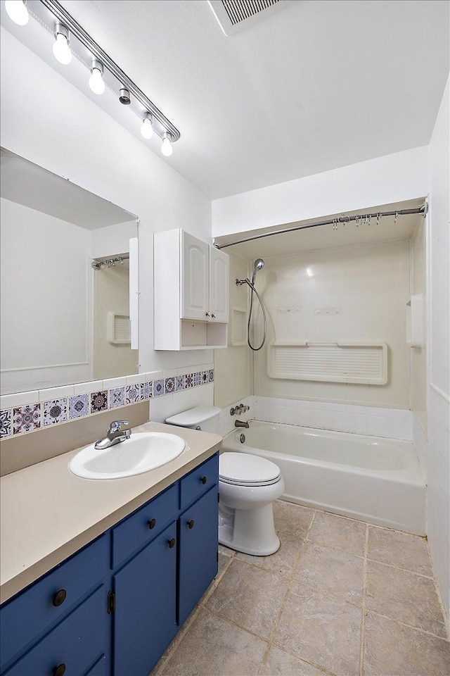 full bathroom with toilet, vanity, decorative backsplash, and washtub / shower combination