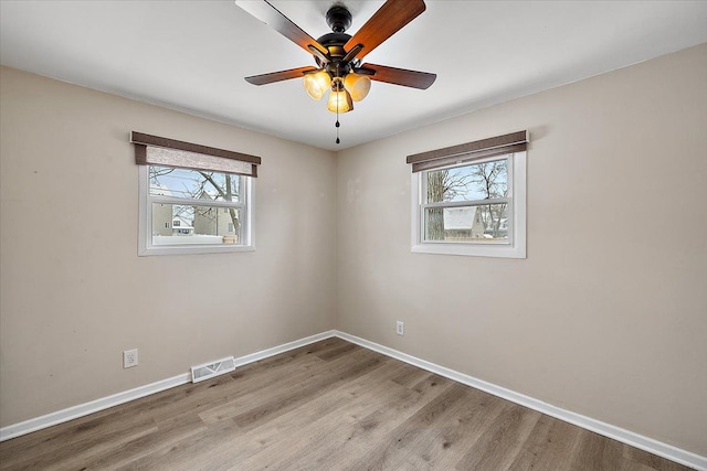 spare room with light wood-type flooring and ceiling fan