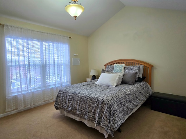 bedroom with multiple windows, carpet, and lofted ceiling