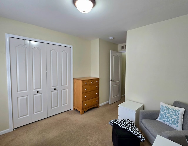 living area featuring light carpet