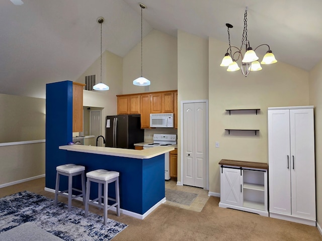 kitchen with a breakfast bar area, decorative light fixtures, high vaulted ceiling, and white appliances