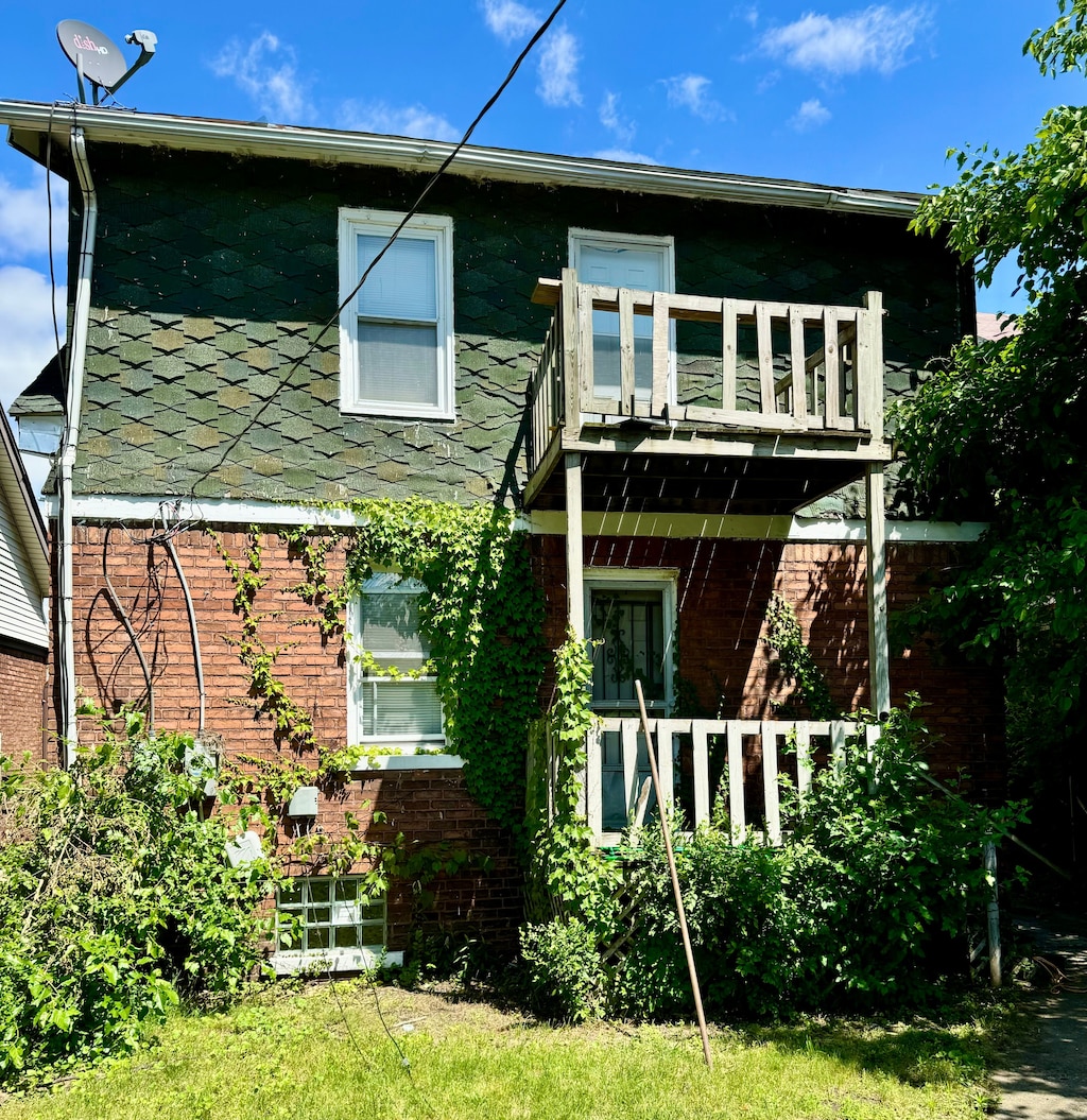 back of property with a balcony