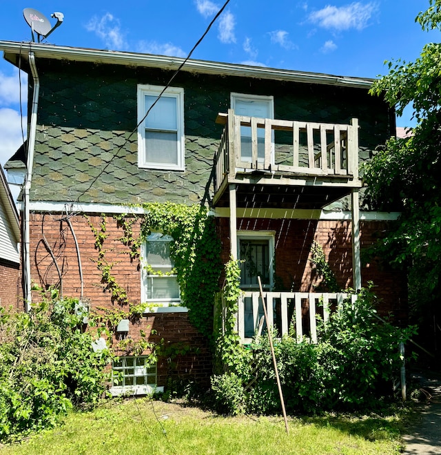 back of property with a balcony