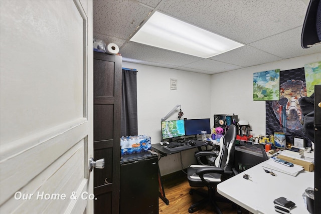 office area featuring hardwood / wood-style flooring and a drop ceiling