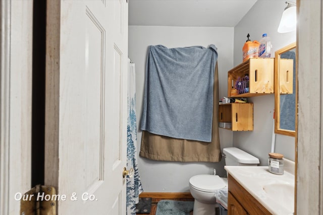 bathroom featuring toilet and vanity