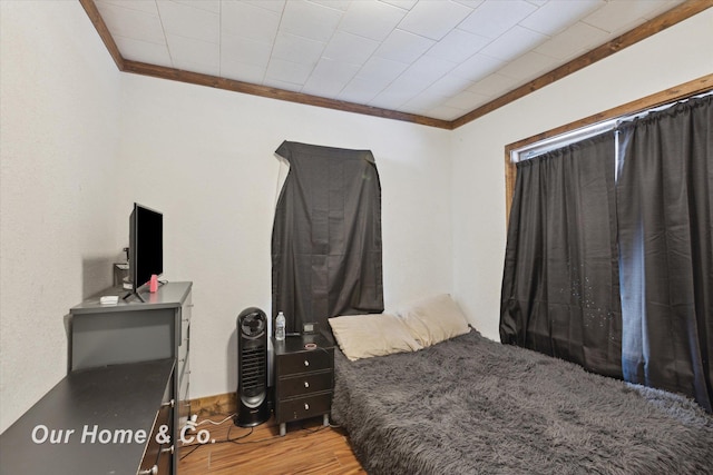 bedroom featuring hardwood / wood-style floors and ornamental molding