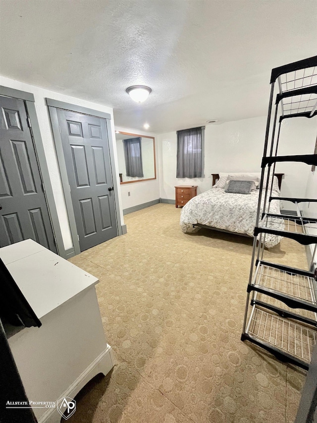 bedroom featuring a textured ceiling and two closets