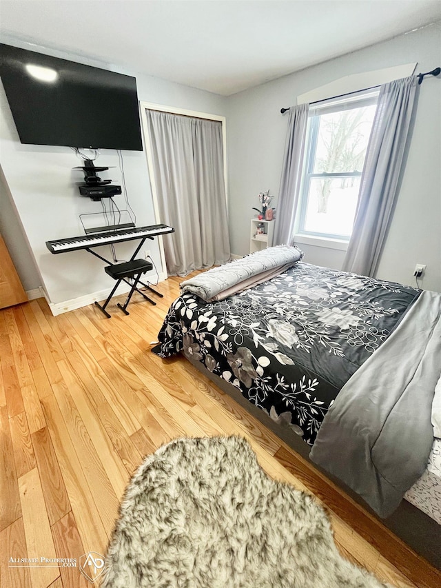 bedroom with hardwood / wood-style flooring