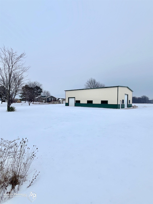 view of snow covered exterior featuring an outdoor structure