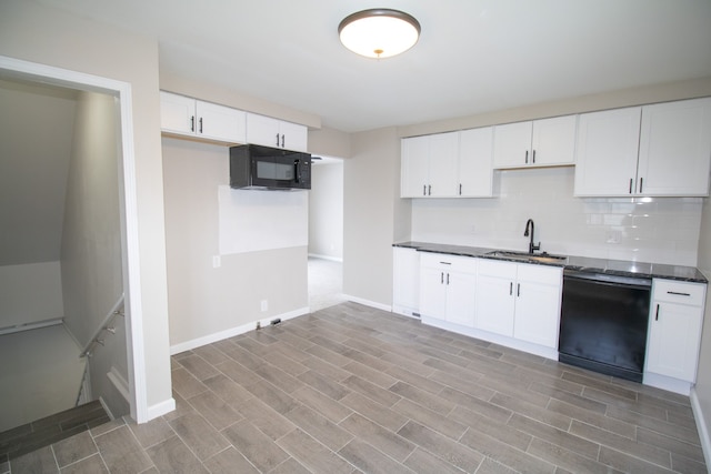 kitchen featuring sink, white cabinets, black appliances, and tasteful backsplash