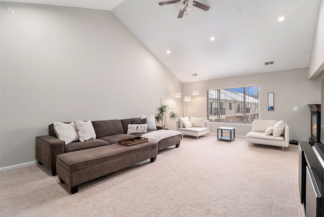 living room with ceiling fan, light colored carpet, and high vaulted ceiling