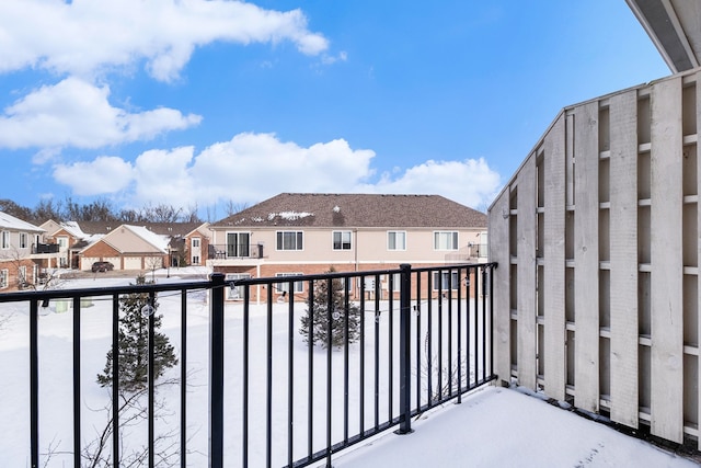 view of snow covered back of property