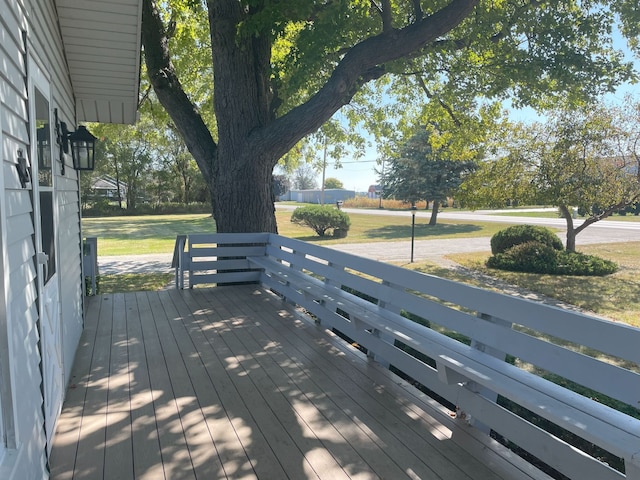 wooden terrace featuring a yard