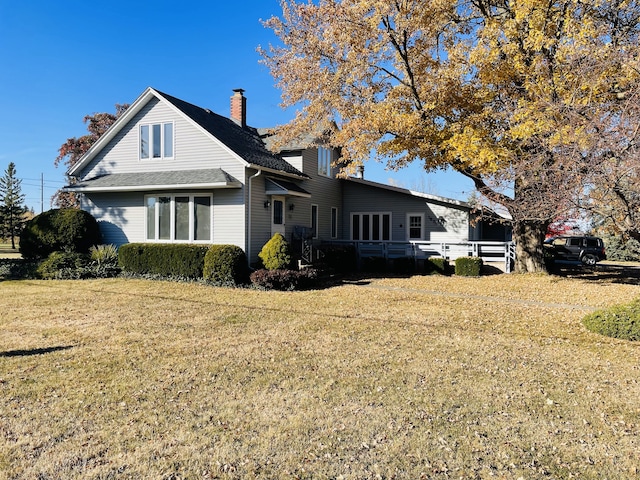 view of side of home featuring a lawn and a chimney